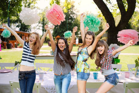Graduates having fun at a graduation party in the backyard